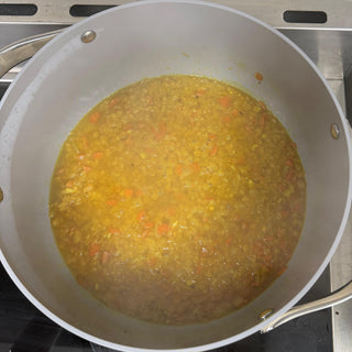 red lentil soup on stove in a pot
